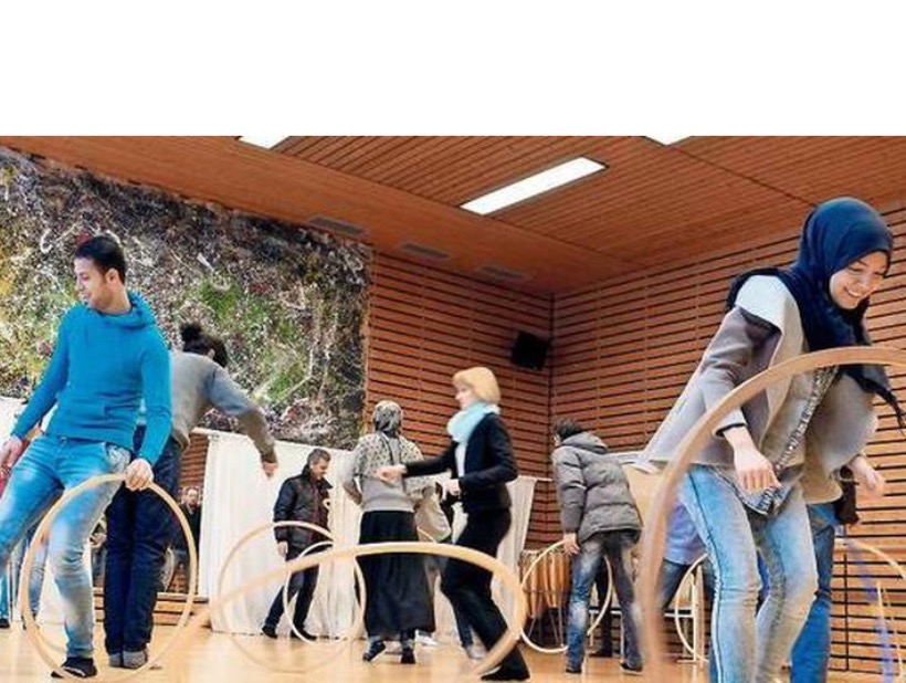 A little boy laughing while reading the Holy Bible